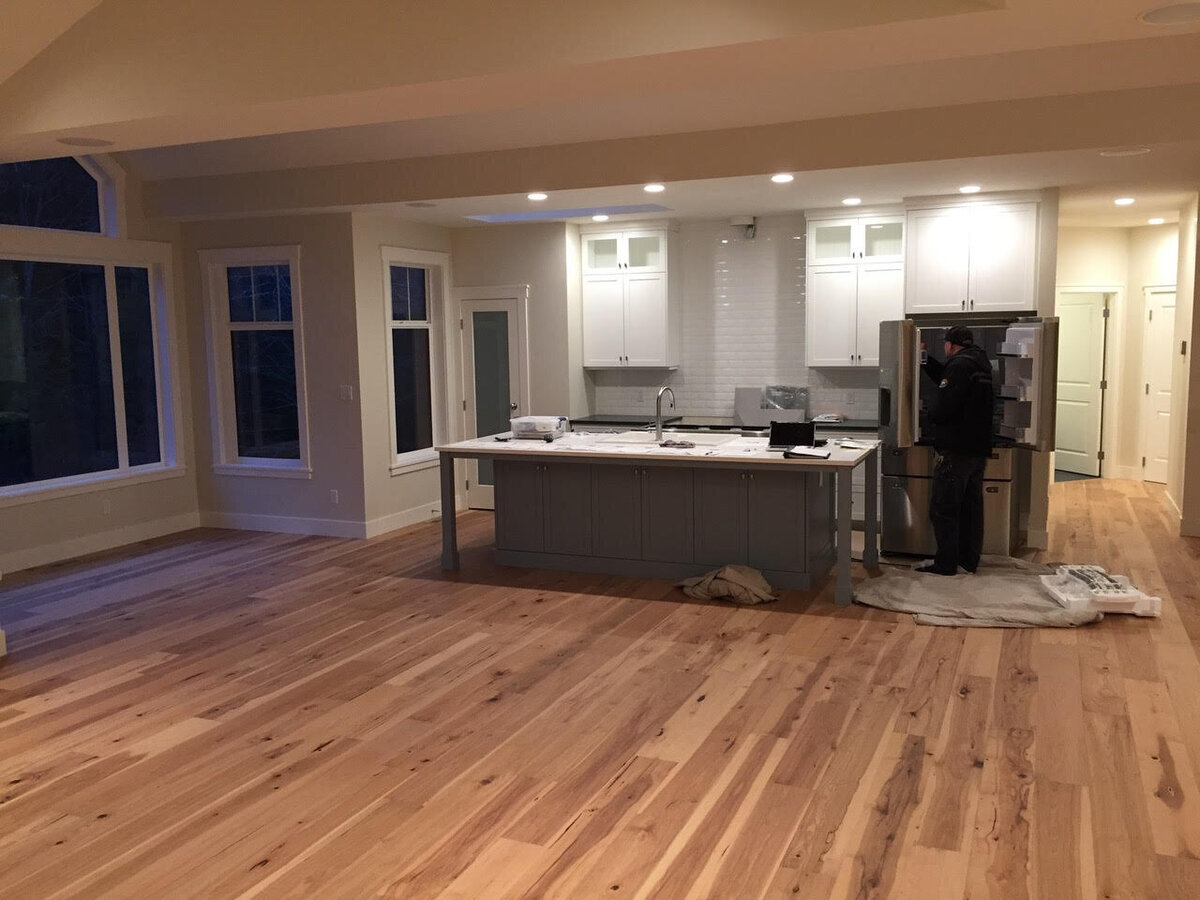Modern craftsman home kitchen design with blue island, subway tile backsplash, and white cabinetry.