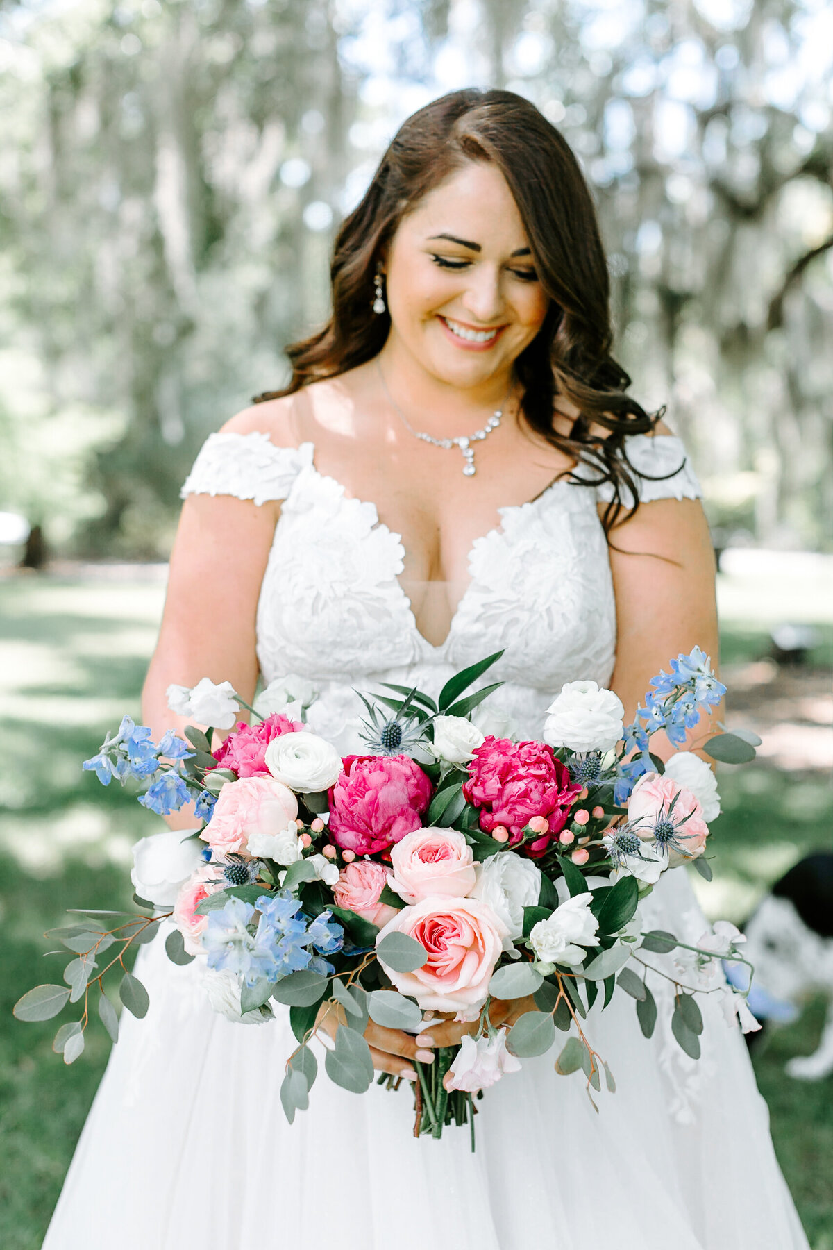 Bride holding bouquet at Magnolia Plantation- wedding coordinator Everything After The Ring