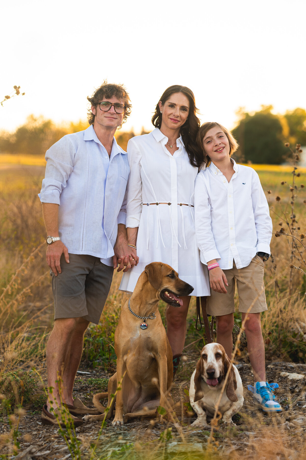 Family smiling together with their dog at sunset — lifestyle family photography in Aledo by Poppy + Blue Photography