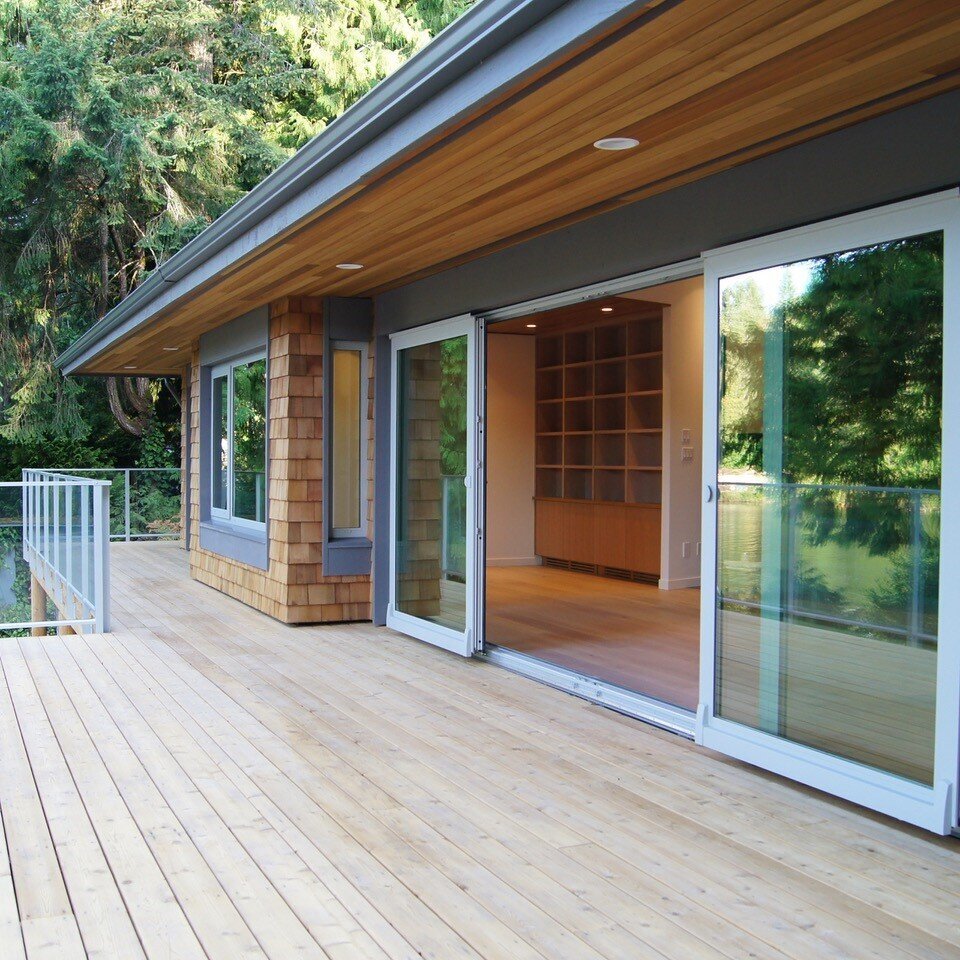 Home exterior design with oversized sliding patio doors, deck and cedar shingles.