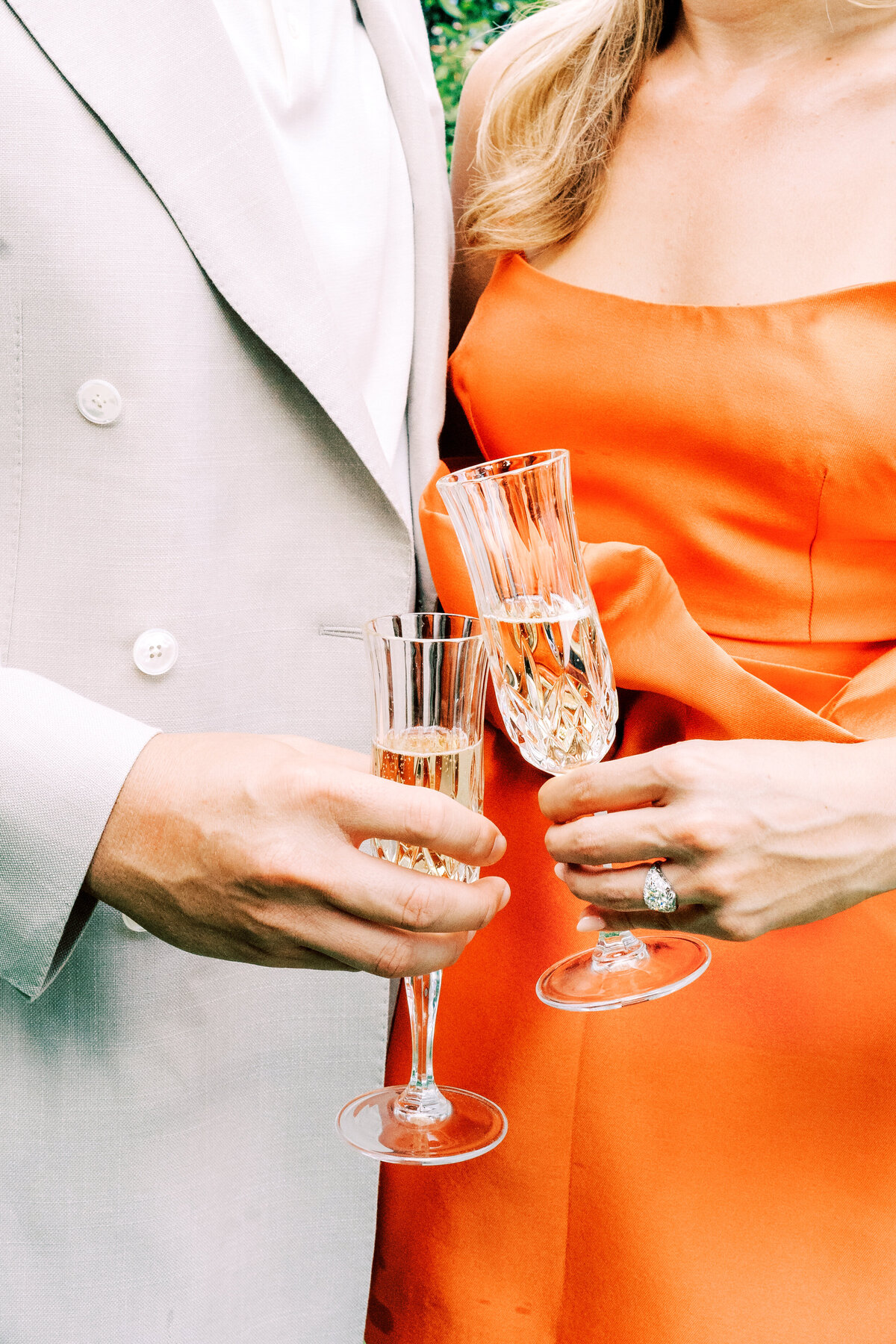 Film photograph of couple giving a cheers with champagne at their  engagement session at Passalacqua on Lake Como Italy