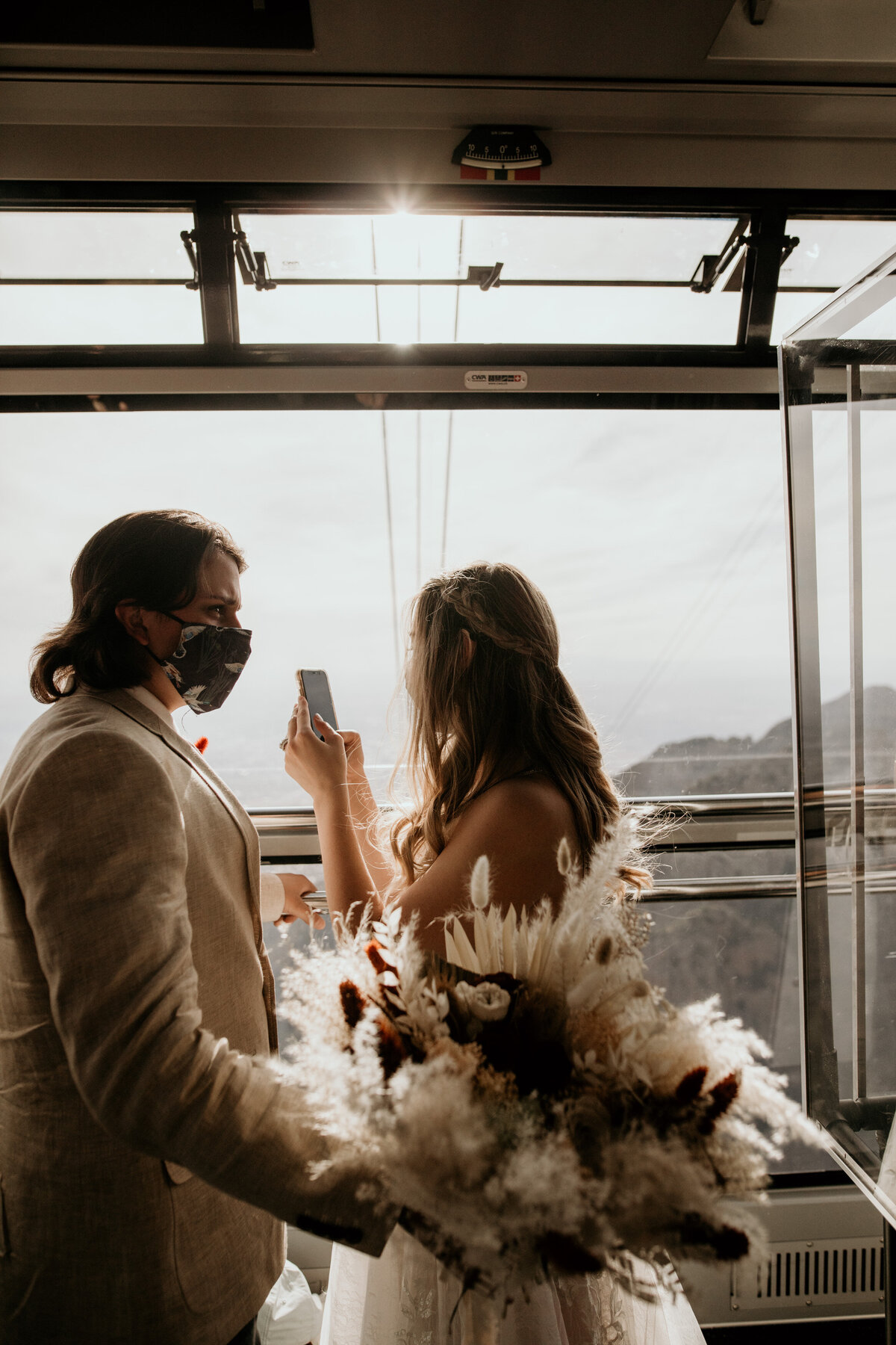 bride and groom riding the sandia peak tram together for their elopement