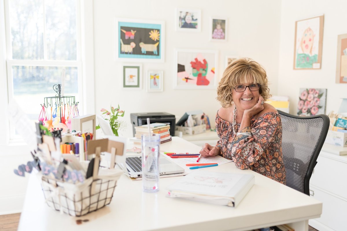 Creative entrepreneur sitting at her white desk for Nashville headshots