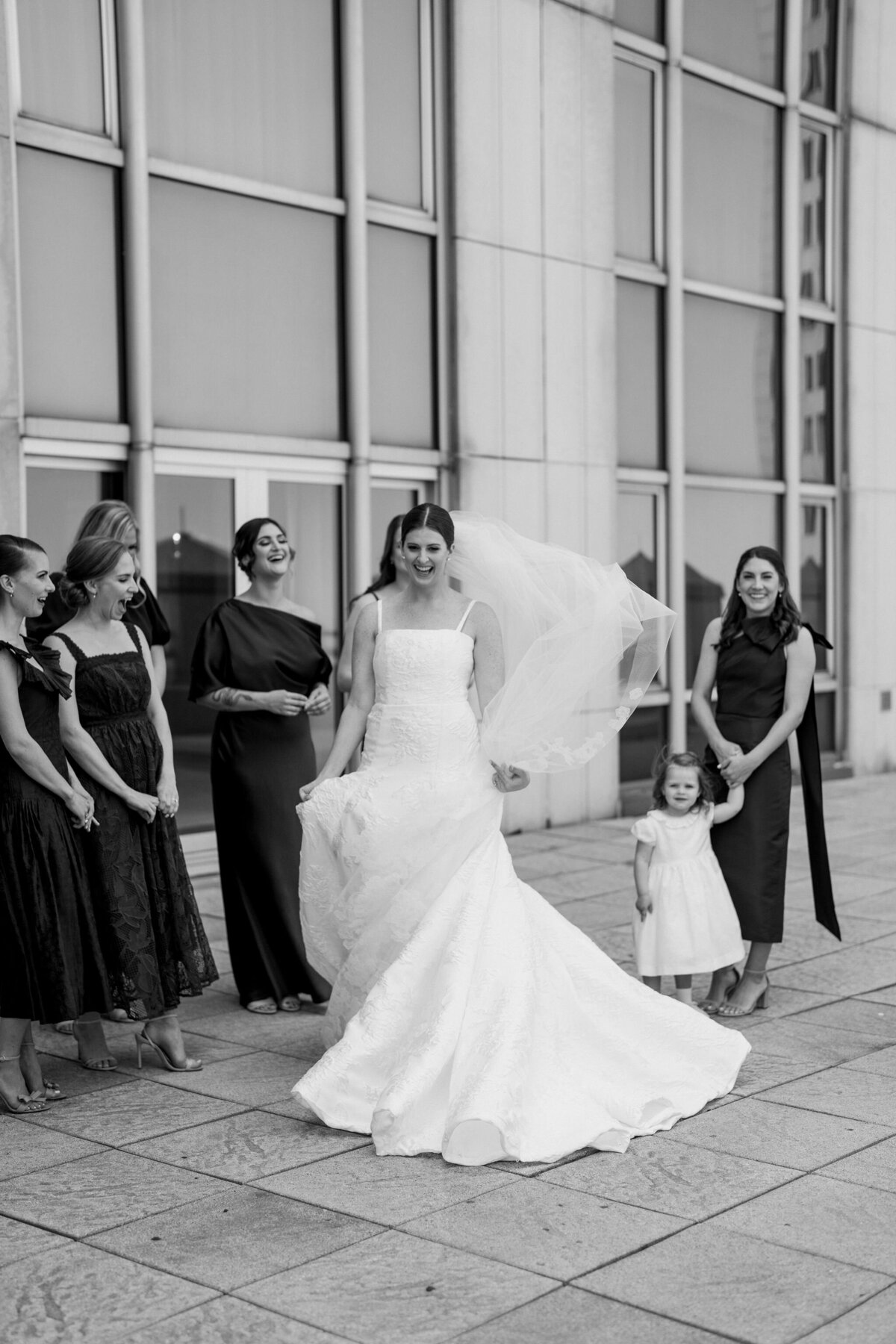 Bride leading her bridal party outside at Saddle Country Club.
