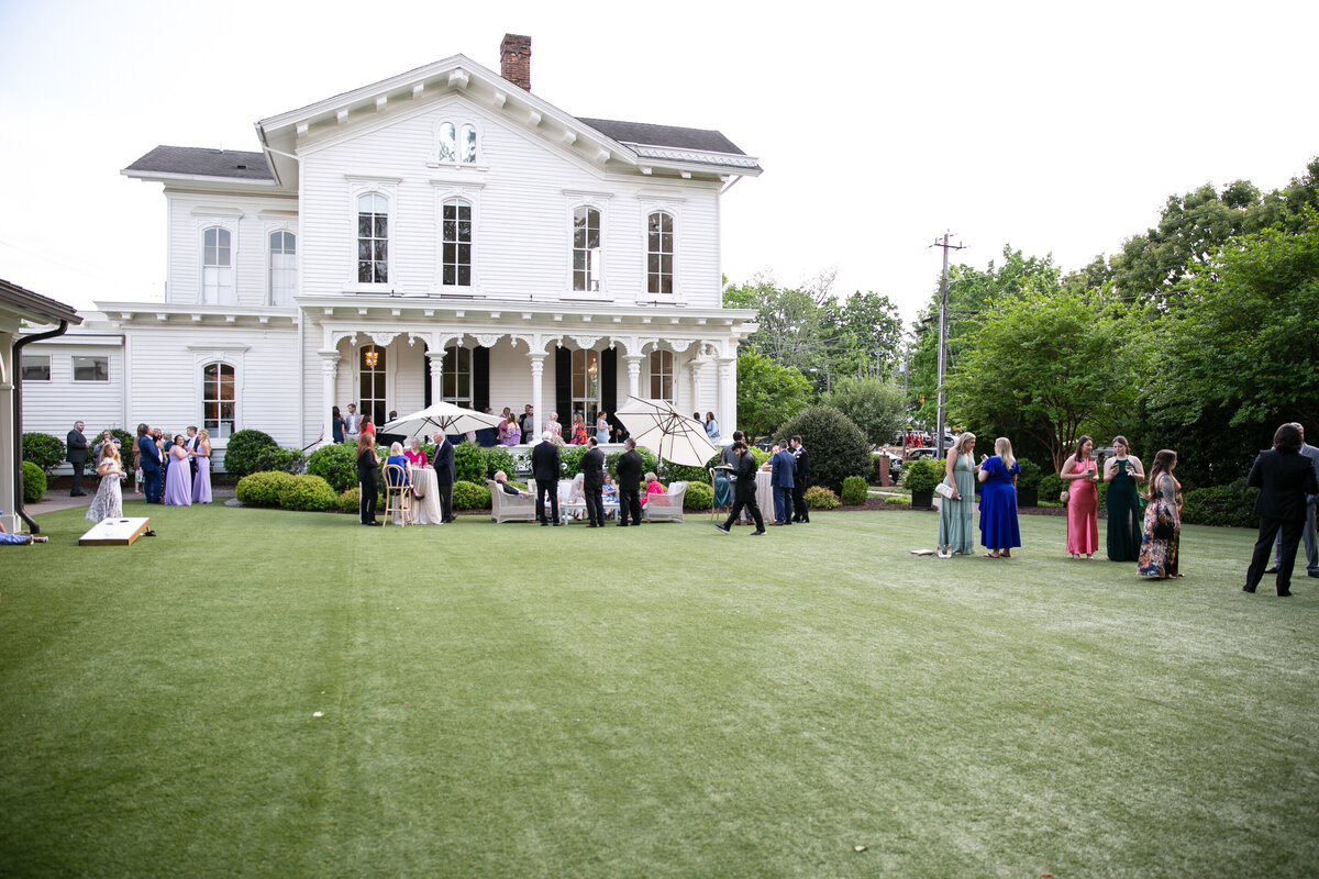 the merrimon-wynne house event photography. Guests enjoying spring evening on the lawn of Merrimon-Wynne House in Raleigh, N.