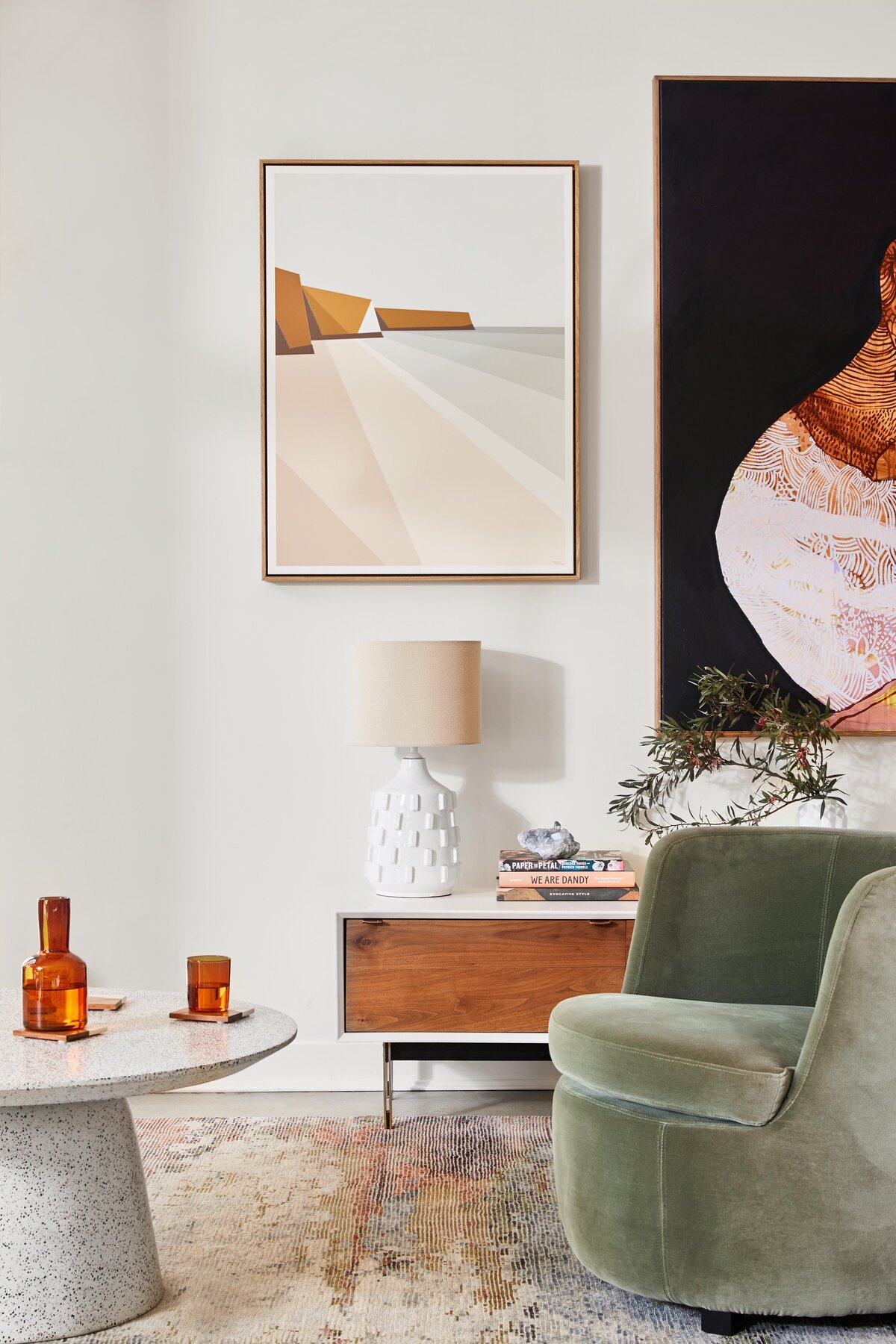 Elwood apartment living room styled with terrazzo coffee table, velvet chair and mid-century artwork