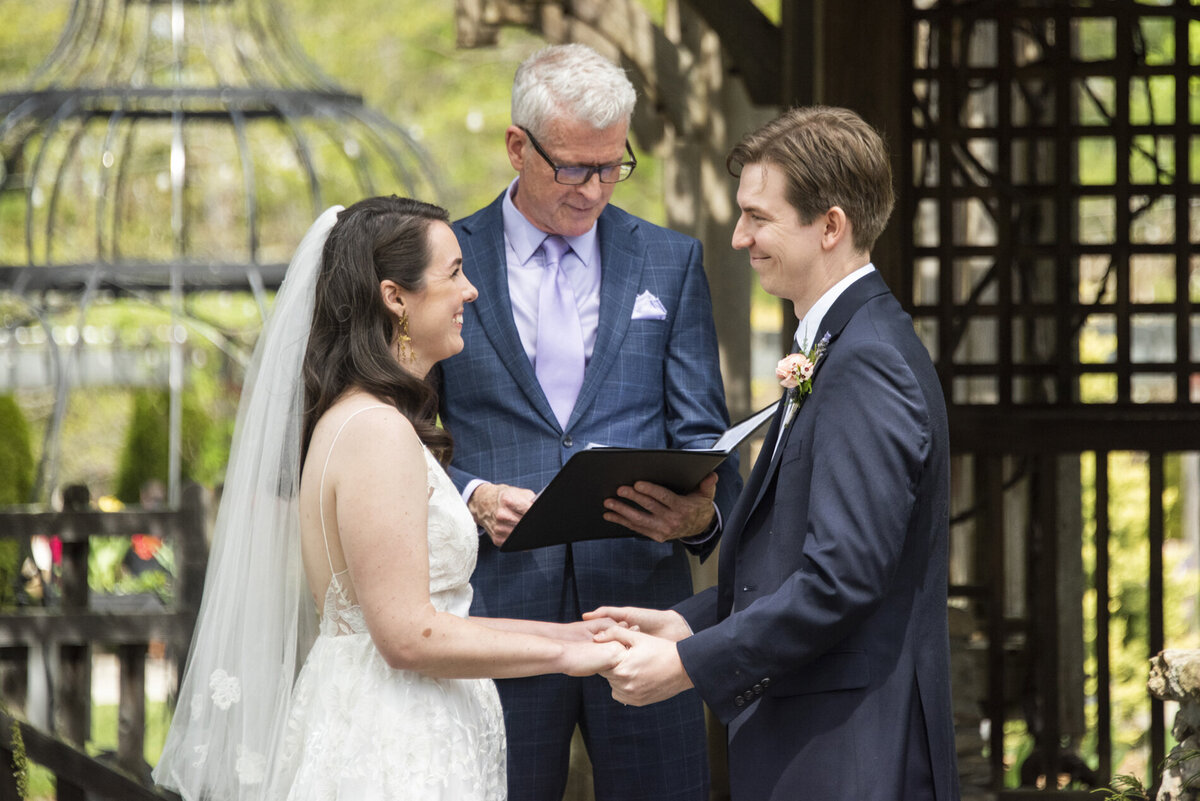 Couple smiling during wedding ceremony 