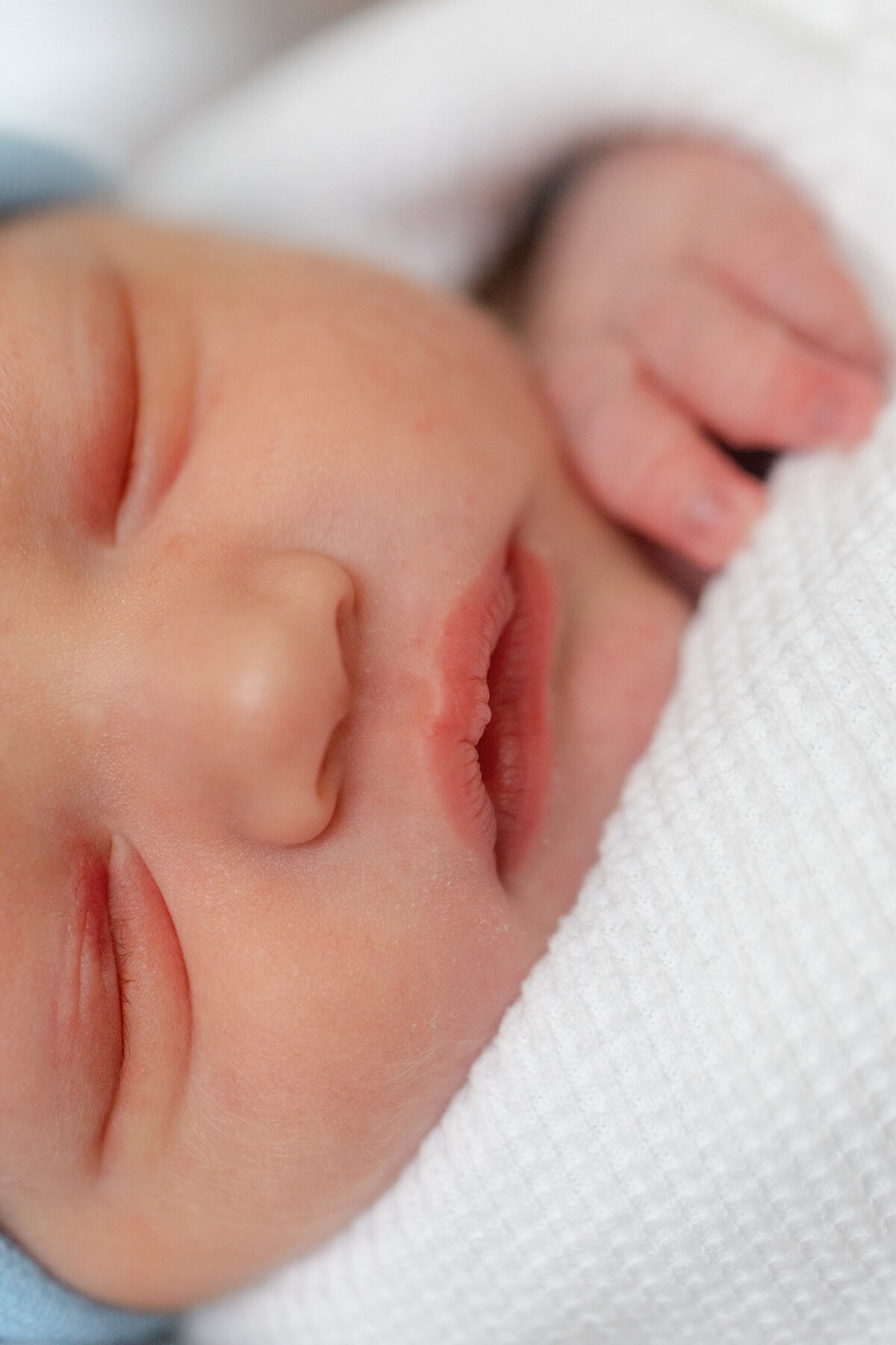 newborn-sleeping-closeup-hand-chin