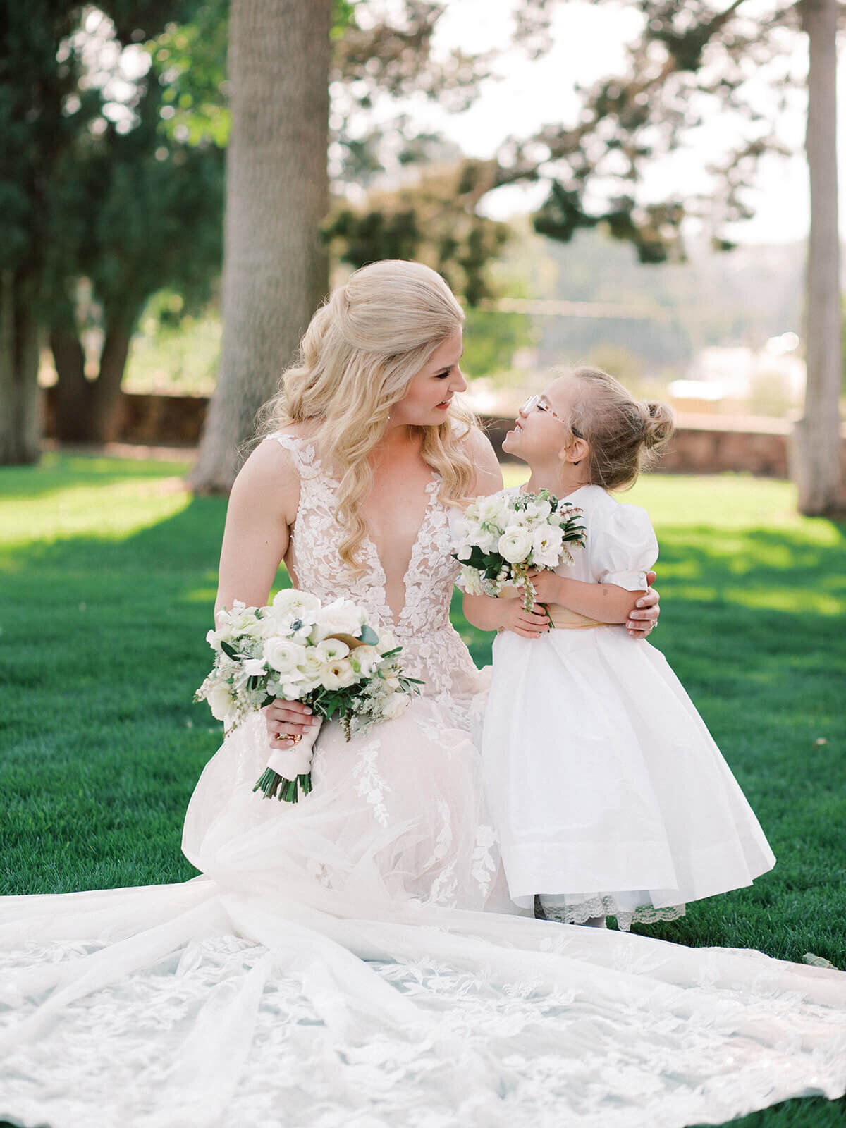 Bride with flower girl and custom floral arrangements