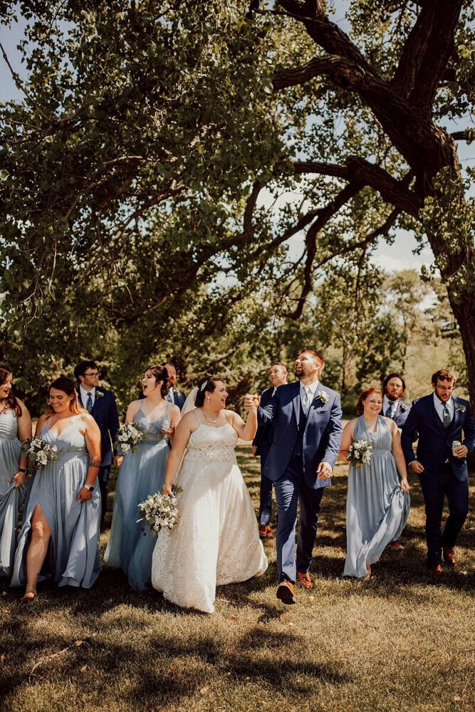 storyteller-collective-photo-co-wedding-party-walk-blue-dresses-in-nebraska