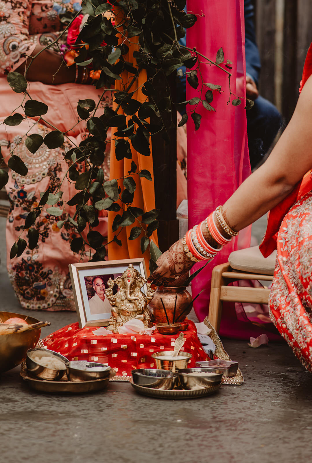 Someone placing an item onto the ground during a traditional wedding ceremony