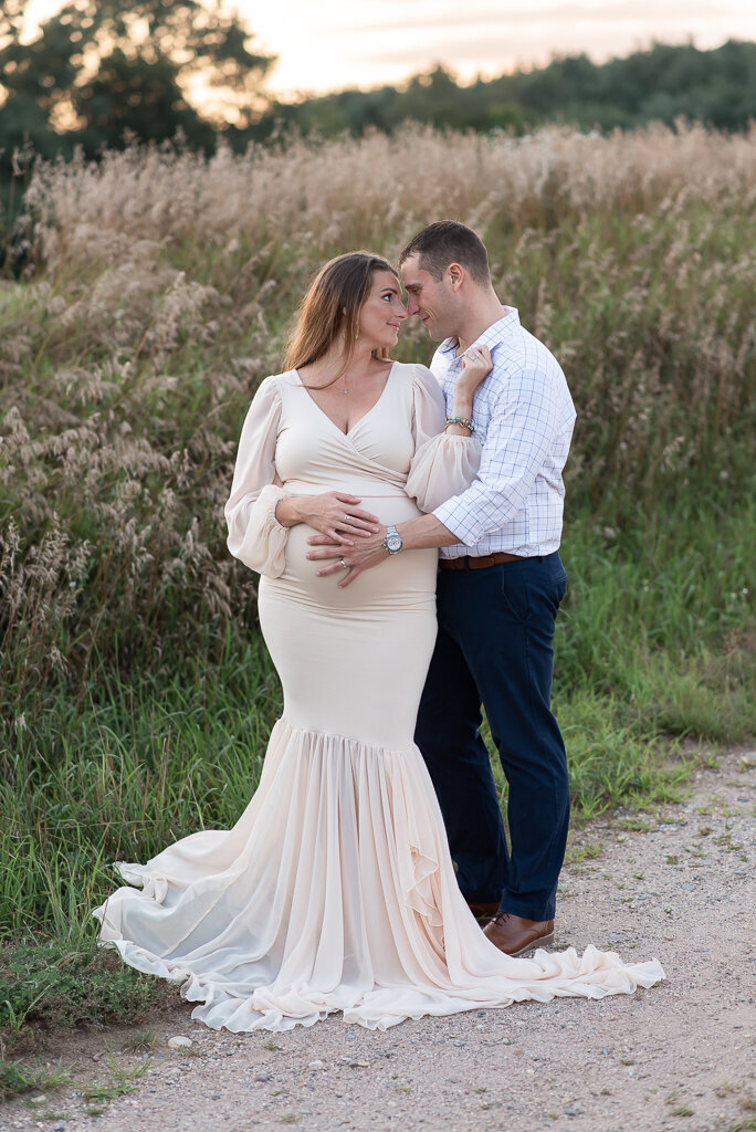 Expecting couple kissing in field at sunset | Sharon Leger Photography | CT Newborn & Family Photographer | Canton, Connecticut