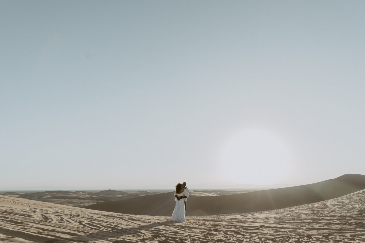 Couple eloping in the Imperial Sand Dunes in California at Sunset
