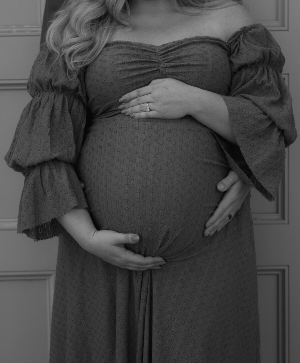 close up of expecting mom's belly wrapping in mom and dad's hands caressing belly