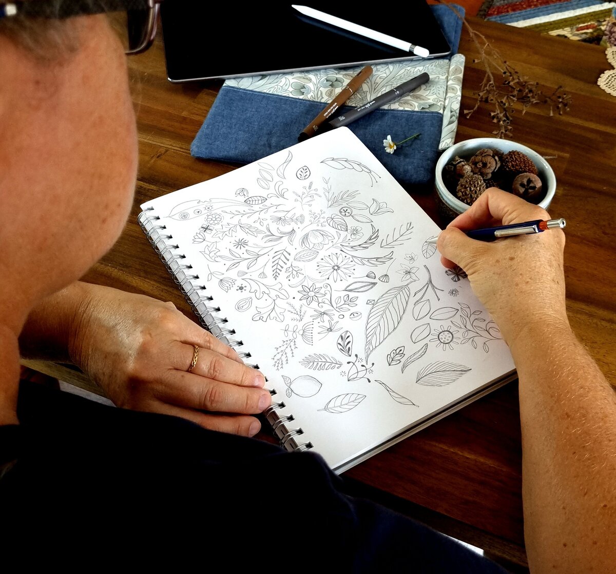 Alison Ashbourne surface designer Green Acre Designs sketching in sketchbook with nuts and flowers