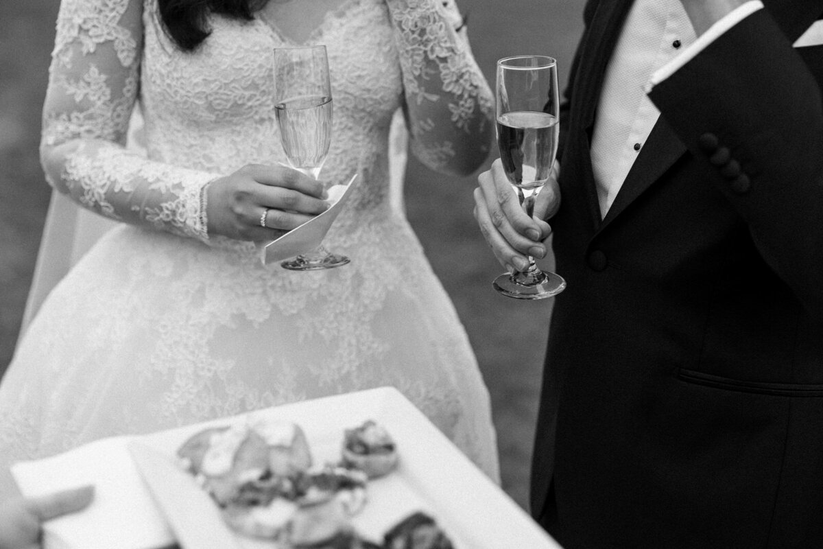 Bride and groom enjoying Champagne and horderves during their cocktail hour at the Rosecliff Mansion in Newport Rhode Island, captured by Andrea-Marie Photography