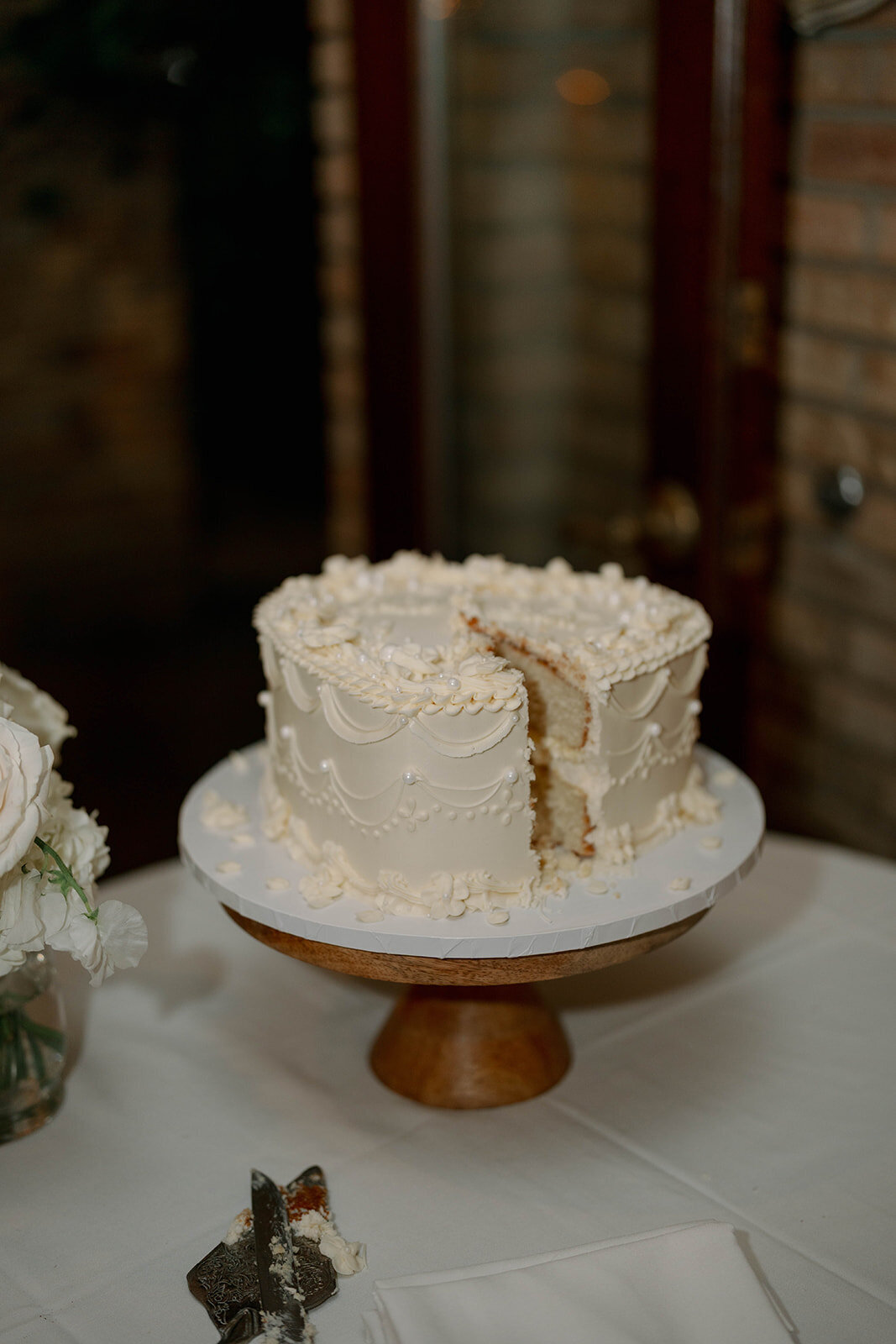 Close-up detail of textured white wedding cake at Café Cortina reception in Michigan.