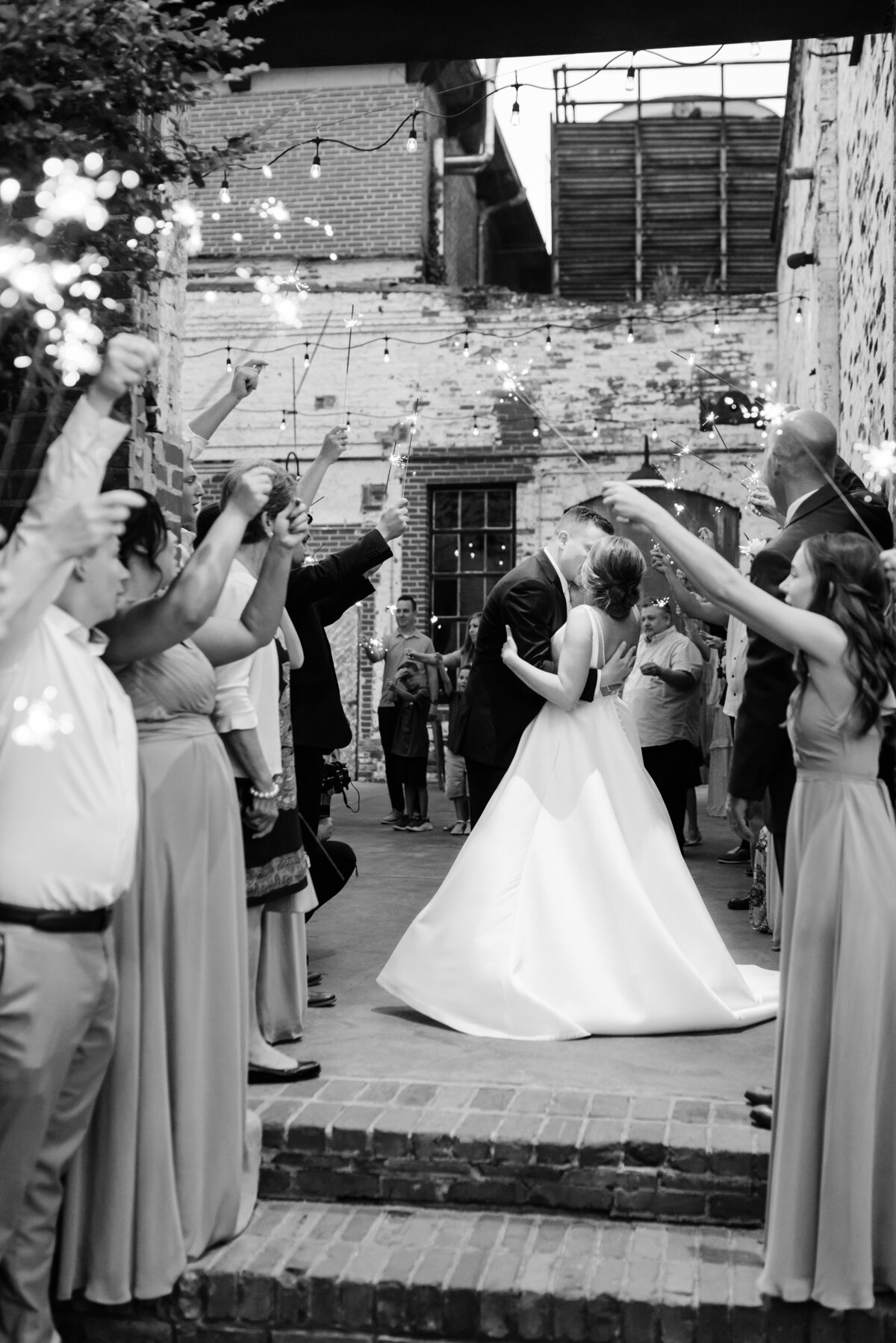 Bride and groom kiss during their sparkler exit at the Engine Room, Monroe, GA 