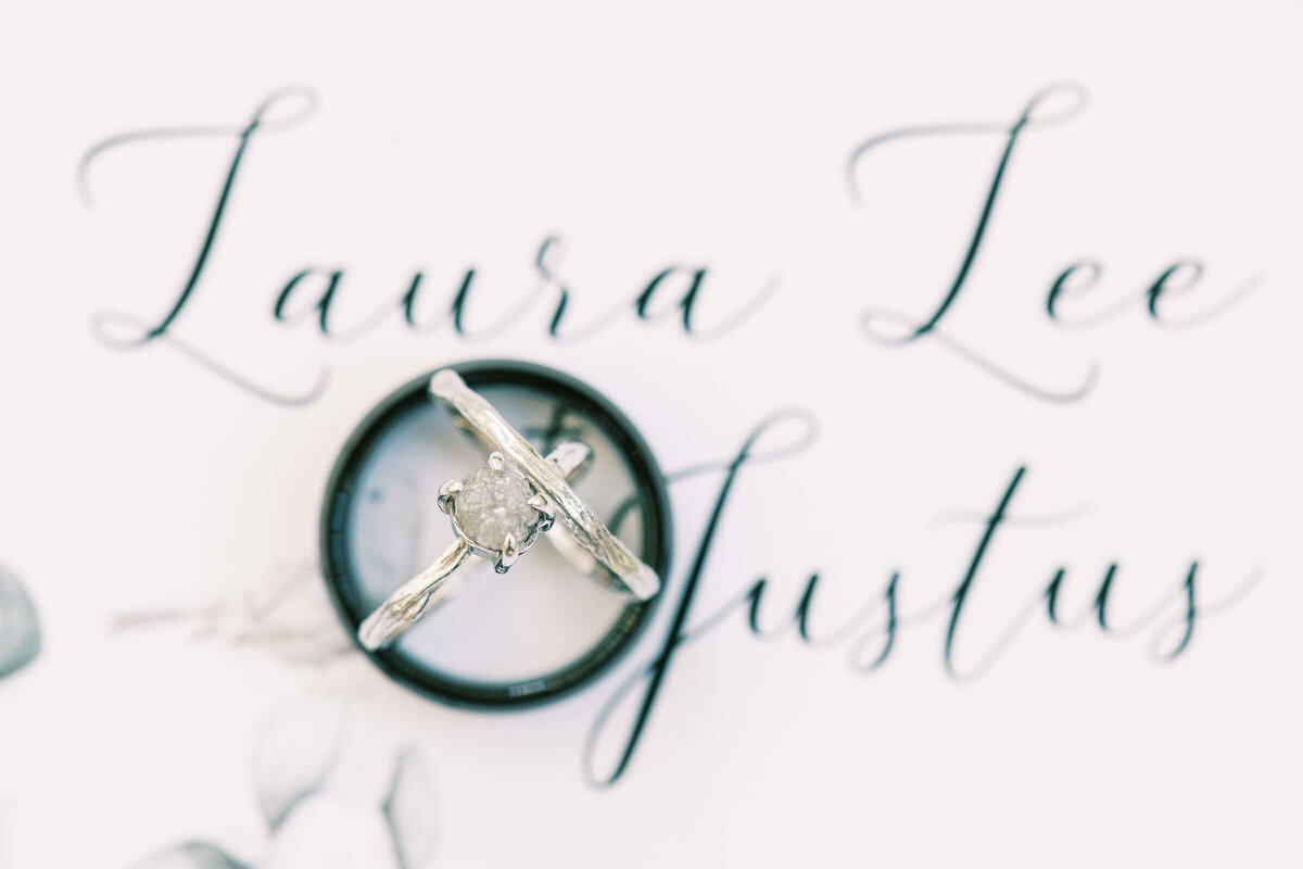 Elegant white gold bride's ring and black groom's ring at Texas wedding