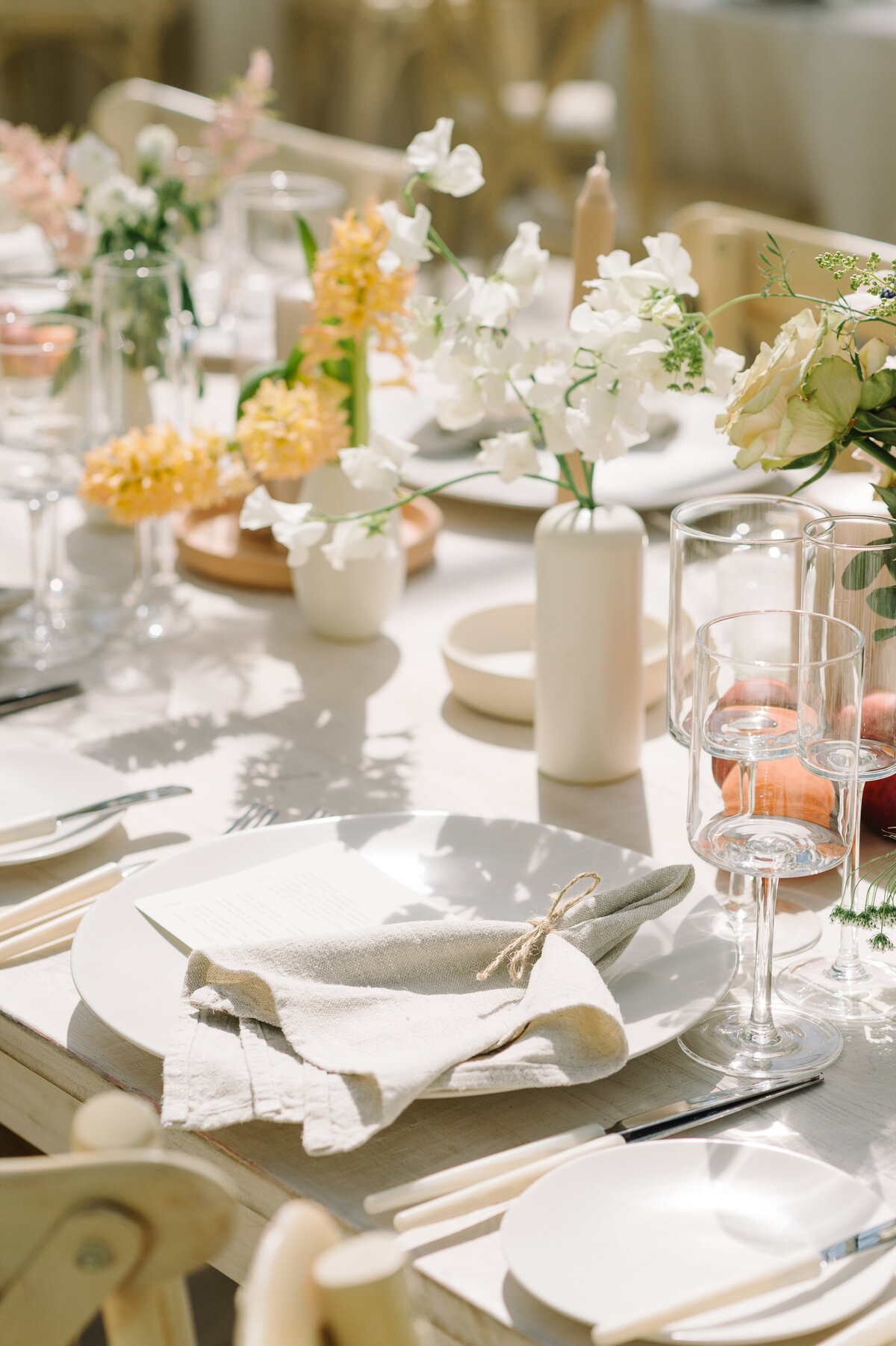 A tablescape with light and shadows photographed at a wedding in Muskoka with Ashley Piggot