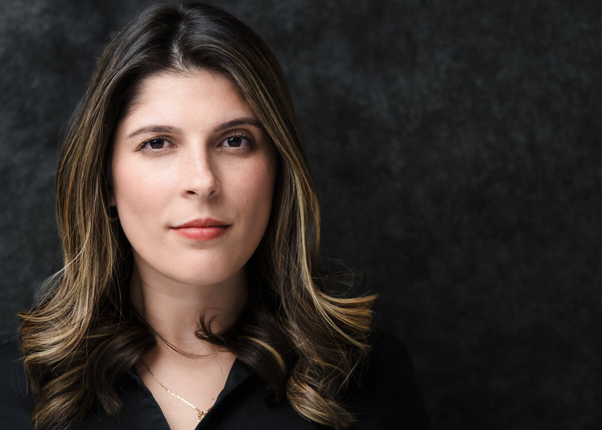 headshot of a woman with a tiny smile