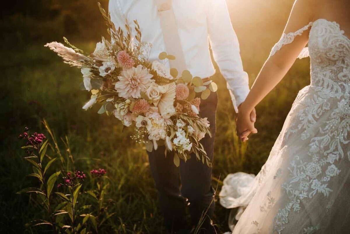 Natalie Brown wedding - bride and groom holding hands