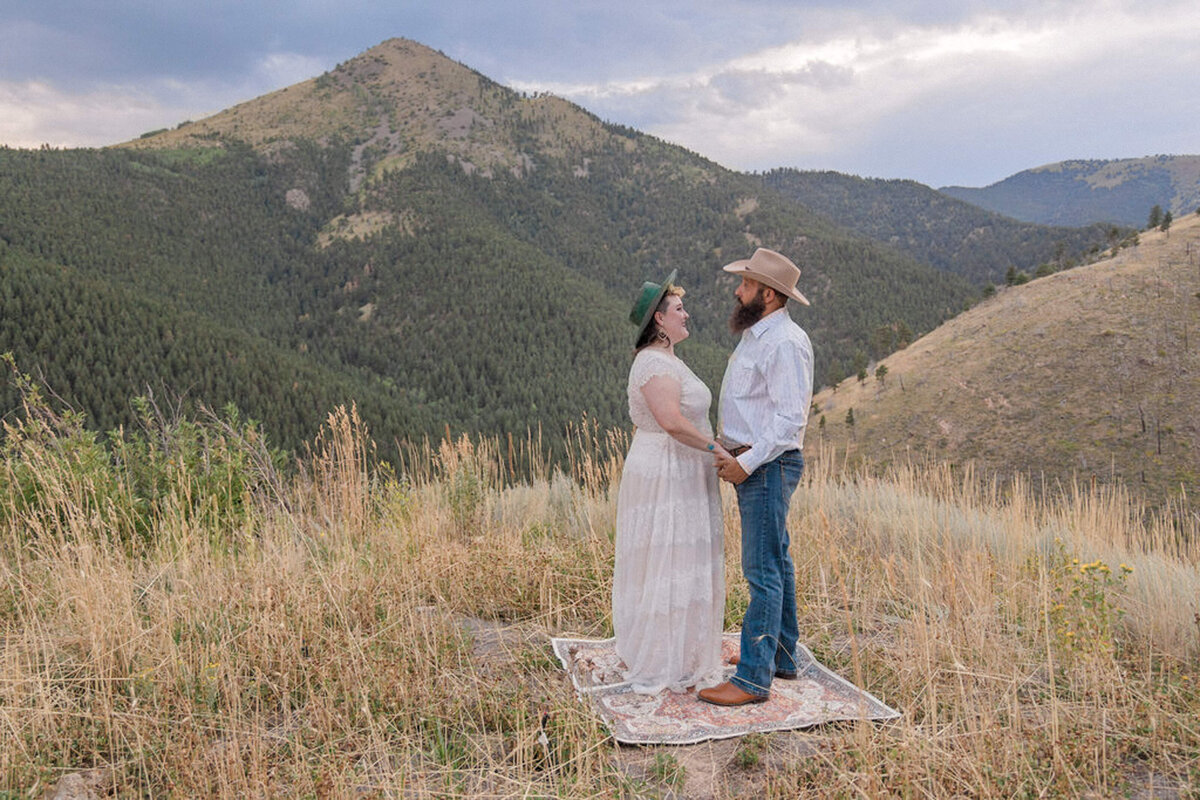 A man and woman look at each other outside of Denver, Colorado during their Colorado elopement wedding.
