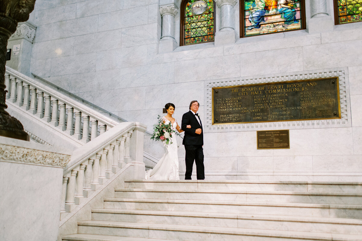 Bride is walking down the aisle at Minneapolis city hall wedding