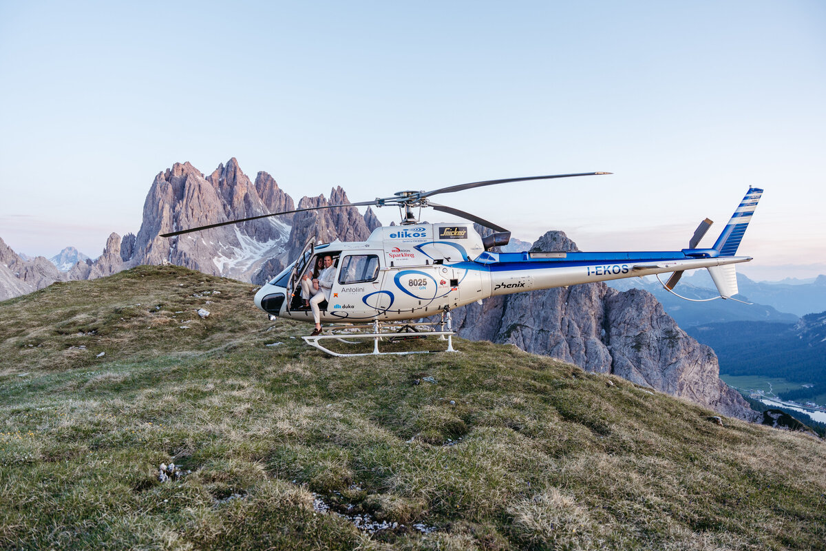 Helicopter flying over Dolomites peaks