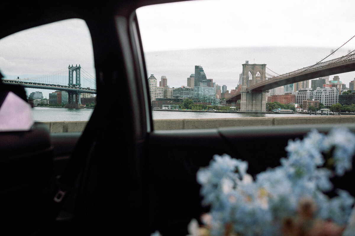 NYC city hall elopement photographer bloom bloom studio bouquet in cab with brooklyn and manhattan bridge