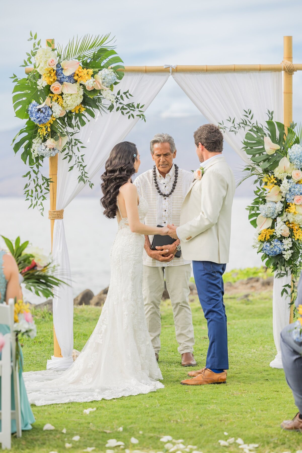 Bride and groom photo during Hawaii wedding ceremony with officiant 