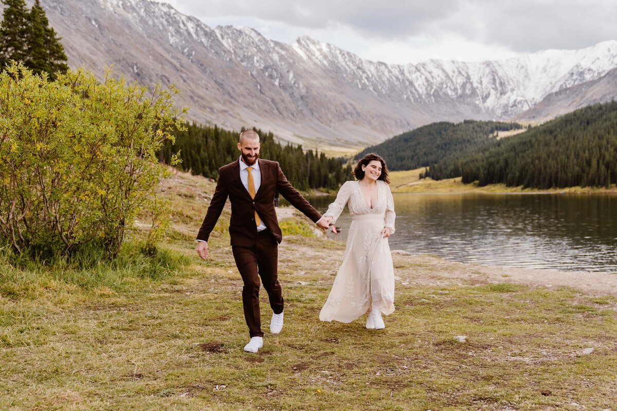Couple elopes at an alpine lake in Colorado in the fall