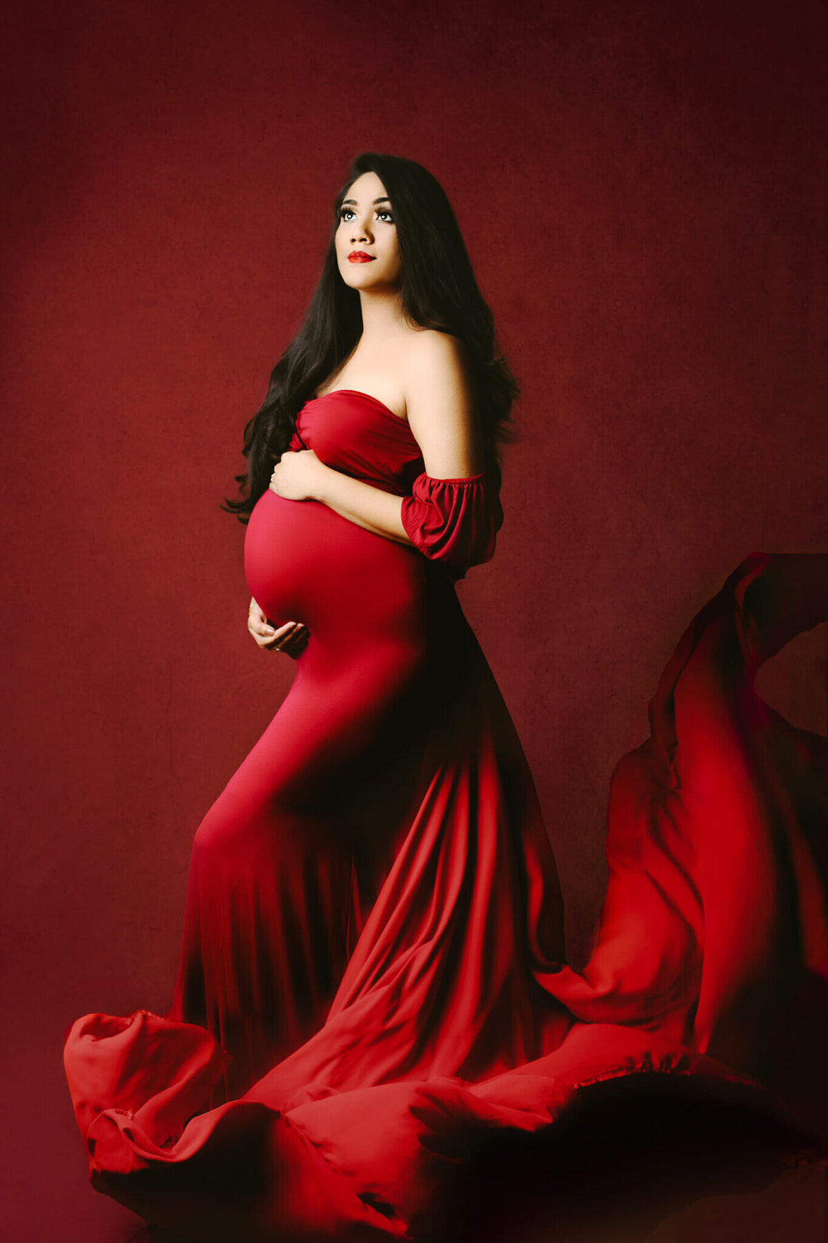 hamilton, On maternity studio poses expecting mother in red dress