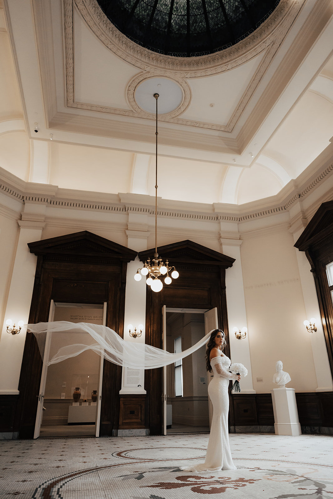 Bride standing under cupola at her Charleston wedding venue