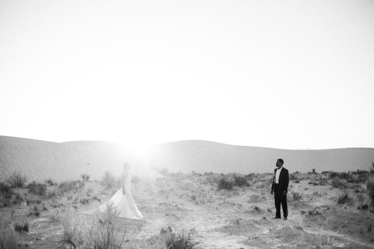 couple walking towards each other in white sands new mexico