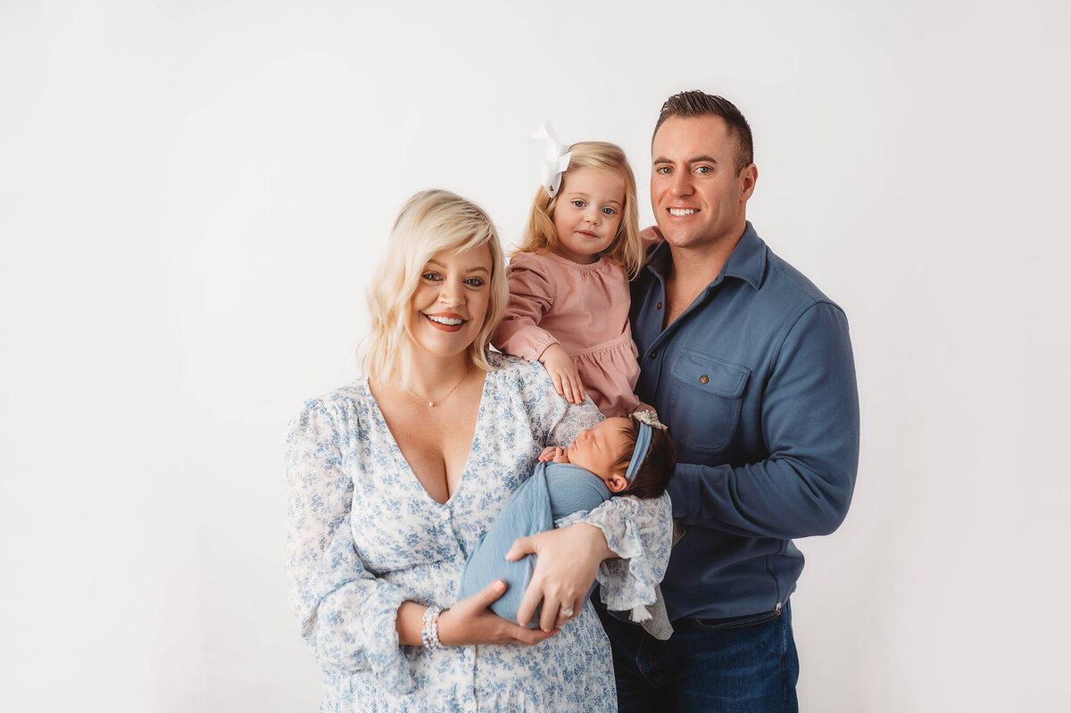 Family poses with their new baby during Newborn Photography Session in Charleston, South Carolina.