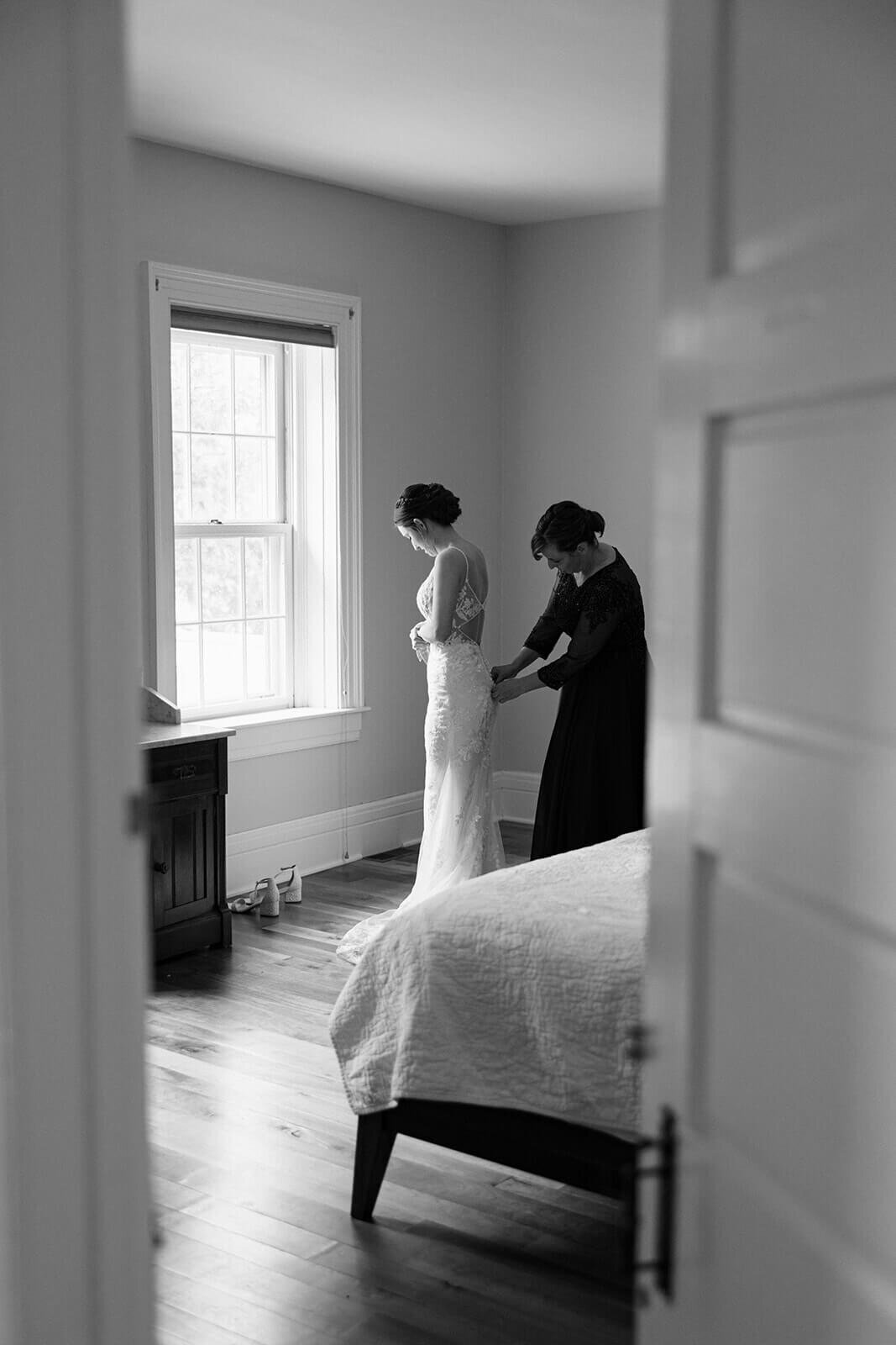 Bride having dress fixed at Finger Lakes wedding, NY