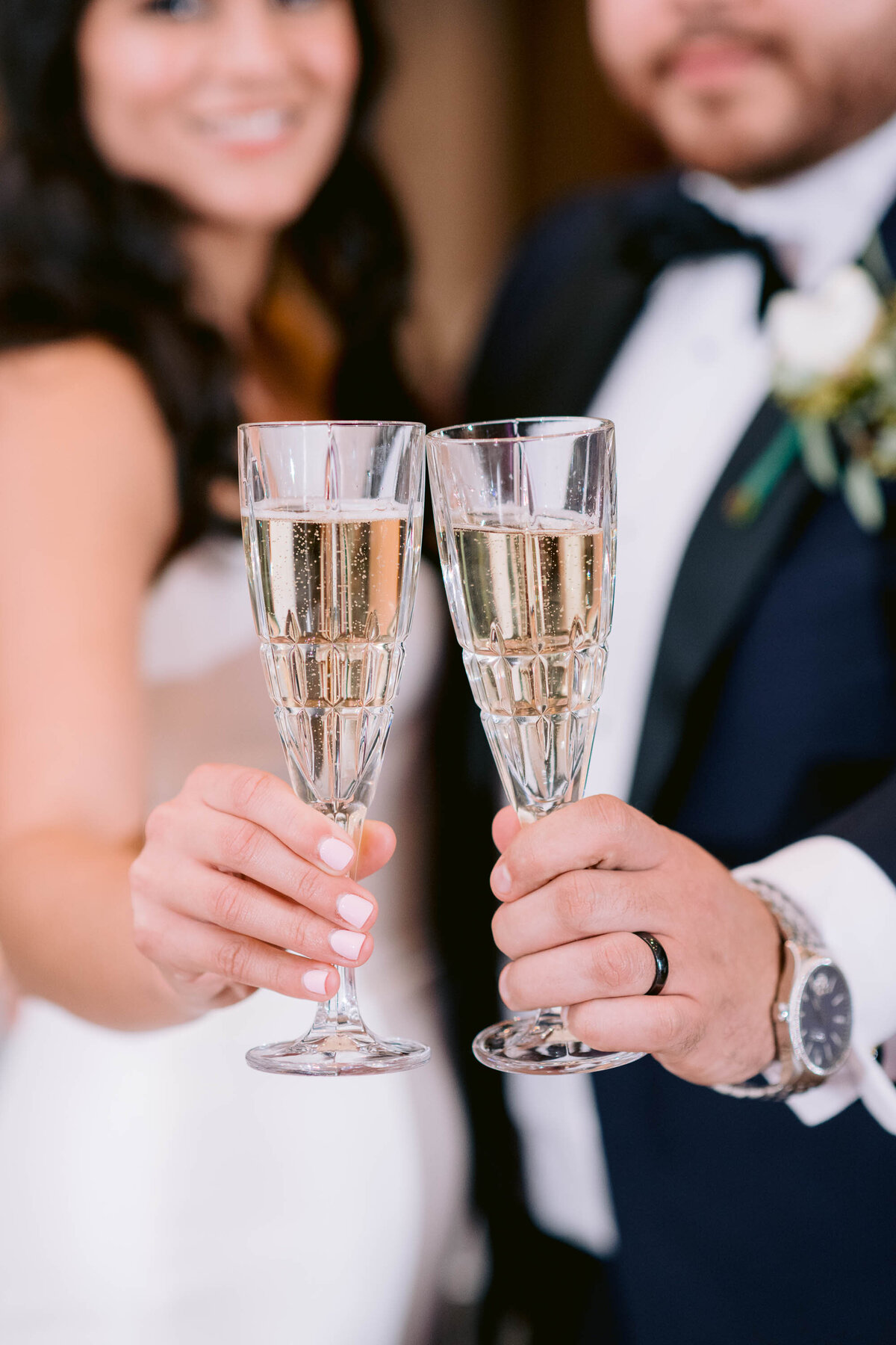 bride and groom holding champagne