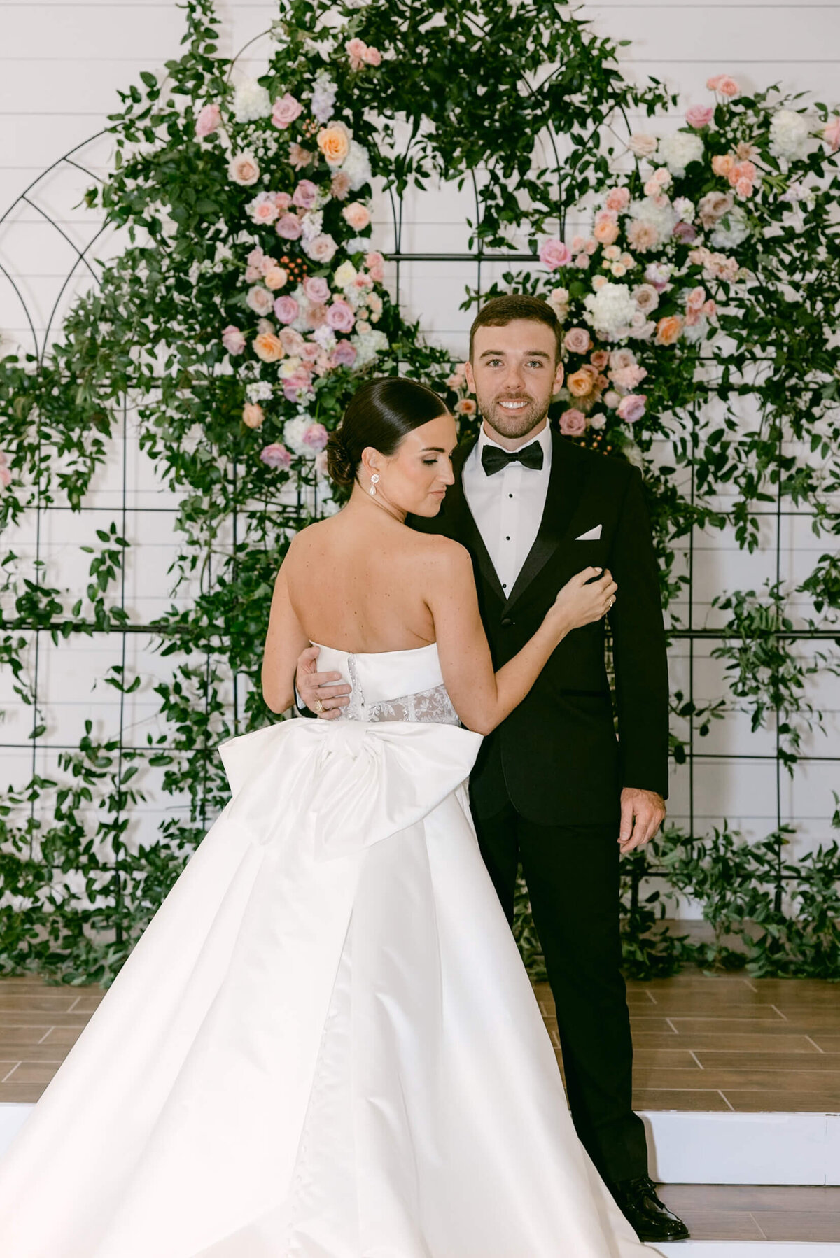 A wedding day photo of the bride and groom posing for a portrait