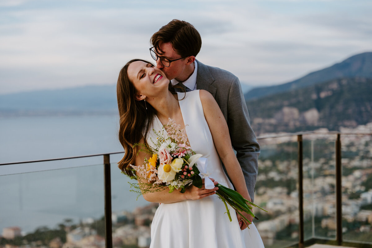 Couple hugging on Sorrento terrace at sunset