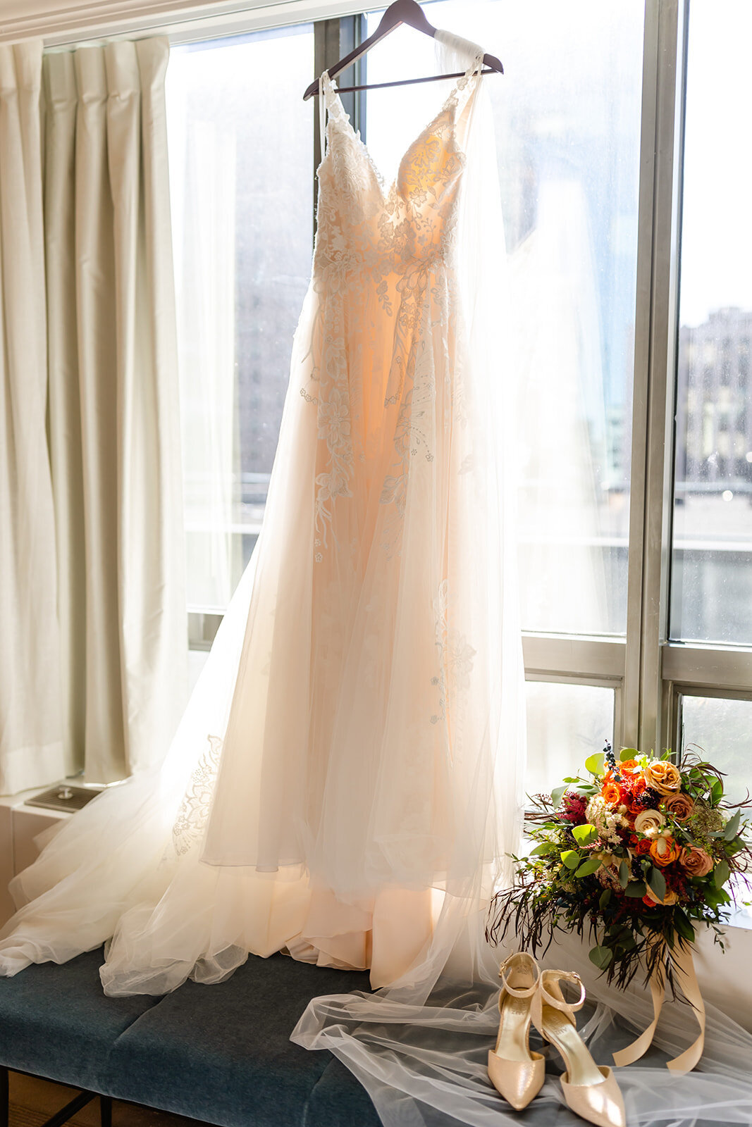 wedding-dress-hanging-bouquet-heels-roses-window