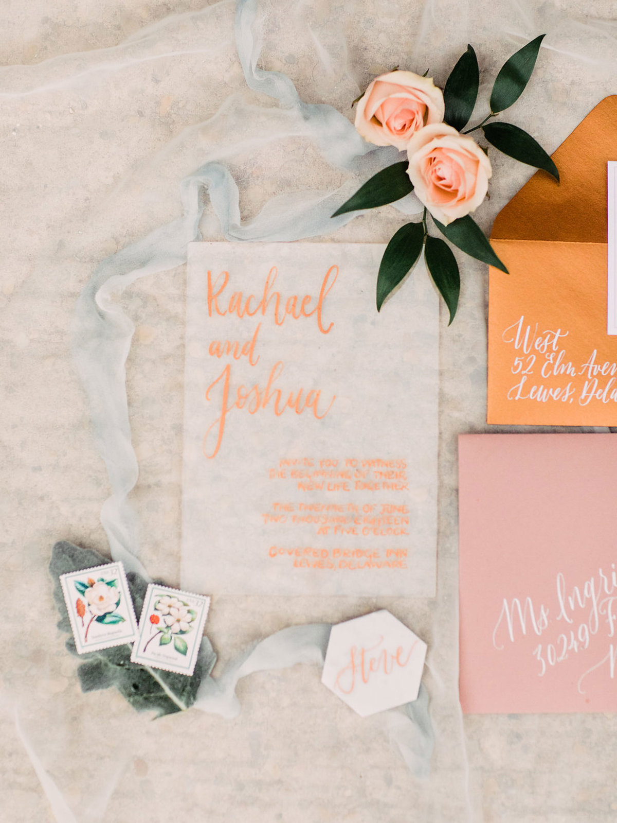 Modern hand lettered wedding invitations with gold and peach