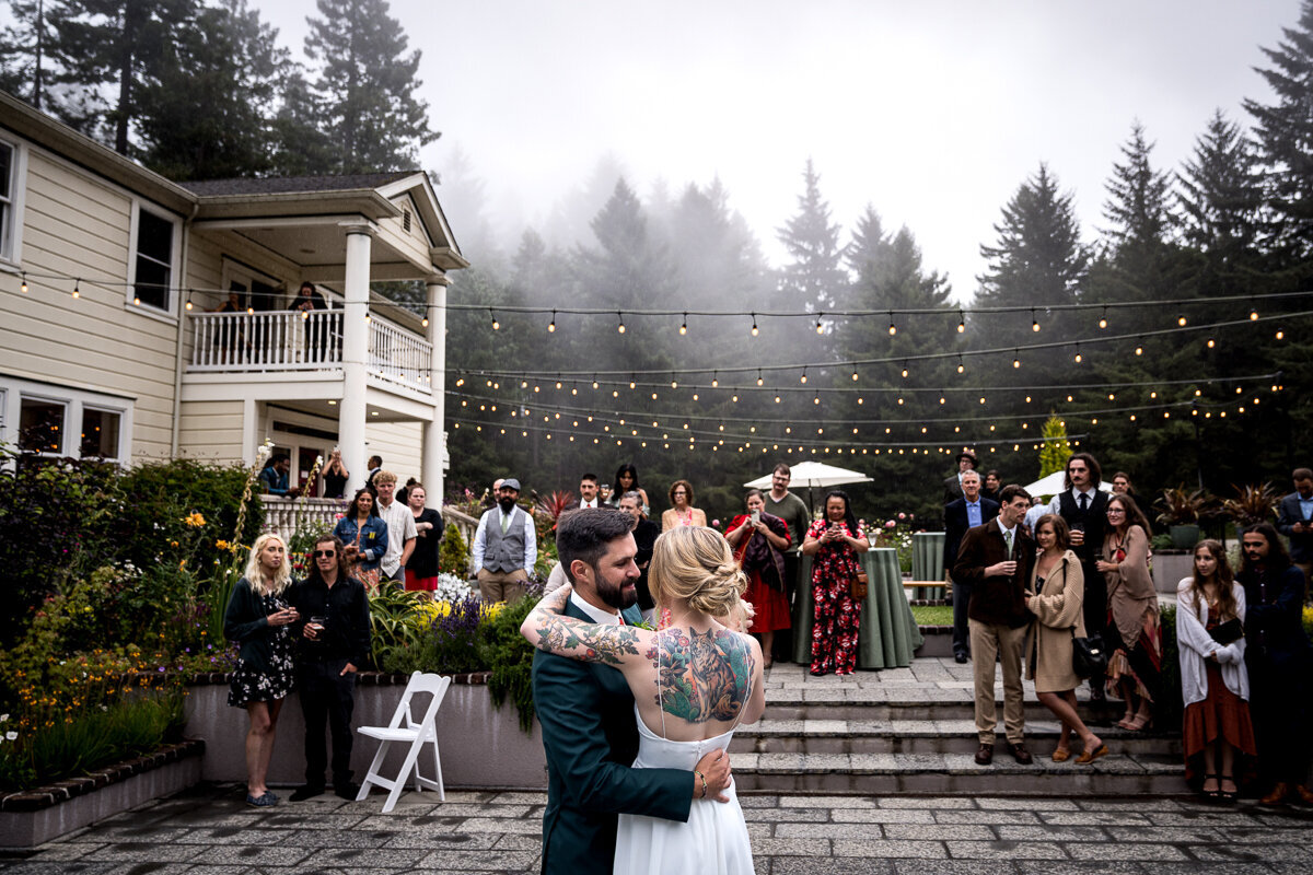 Bride and groom share first dance at Ridgefield Weddings, a Northern California forest wedding venue, surrounded by soft fog.