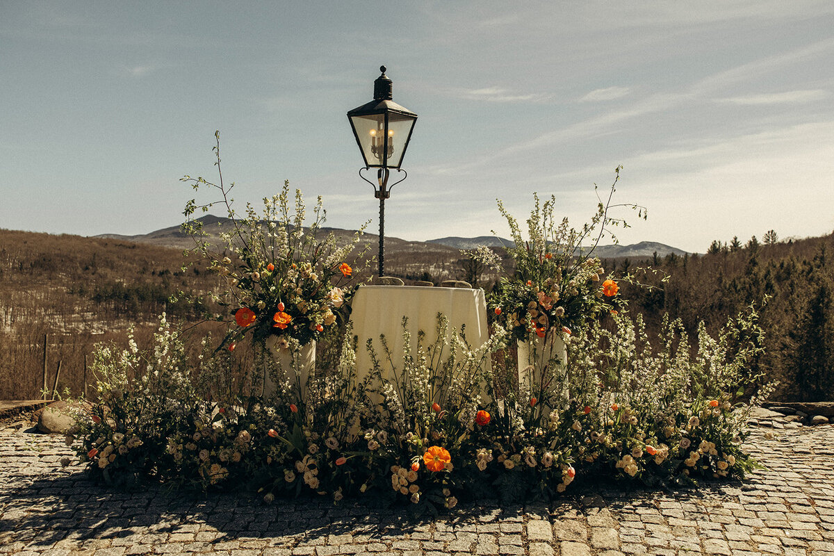 An elaborate, moody set of floral arrangements for a wedding ceremony at Chateau Ste-Agnes.
