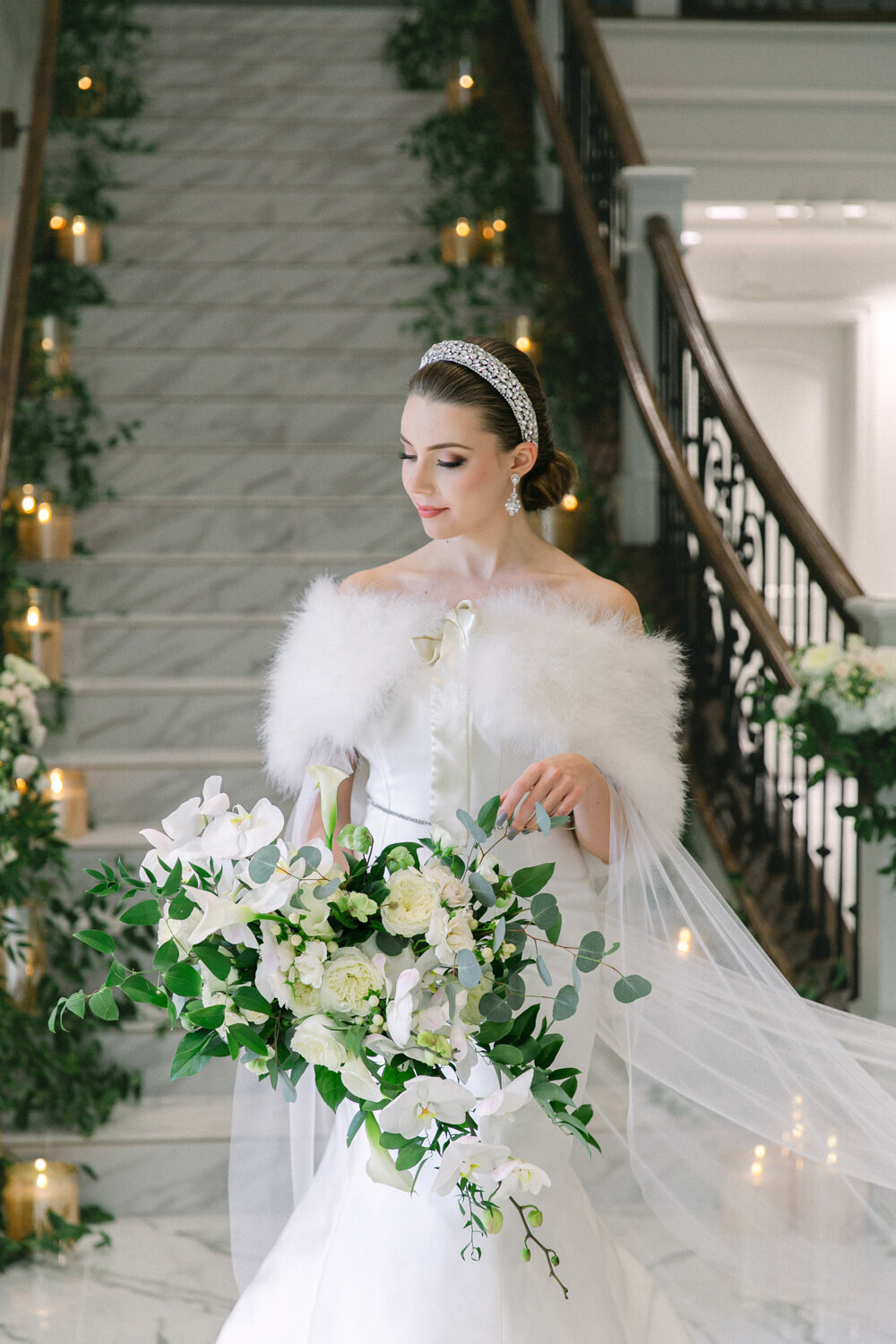 Winter wedding portrait of the bride wearing a fur cover and a crystal headband