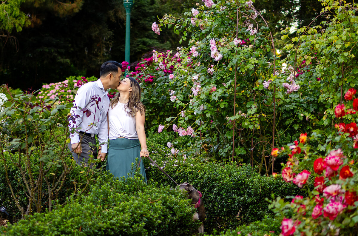A joyful couple's portrait session in a blooming garden captured by San Mateo family photographer