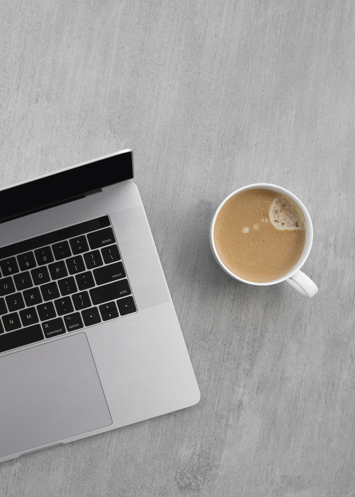 Stock image of a laptop and coffee to show that this home value calculator is accessed on a computer