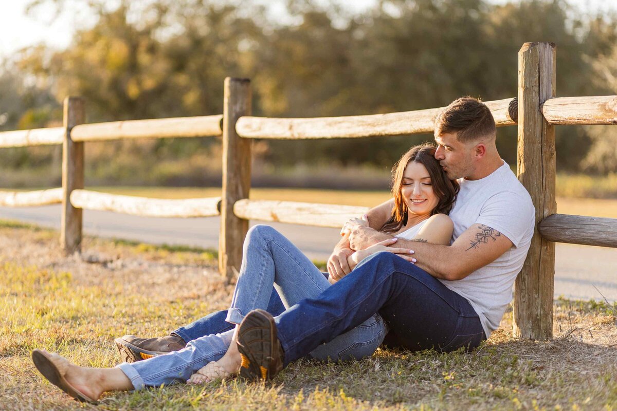 12-couple-sitting-against-fence