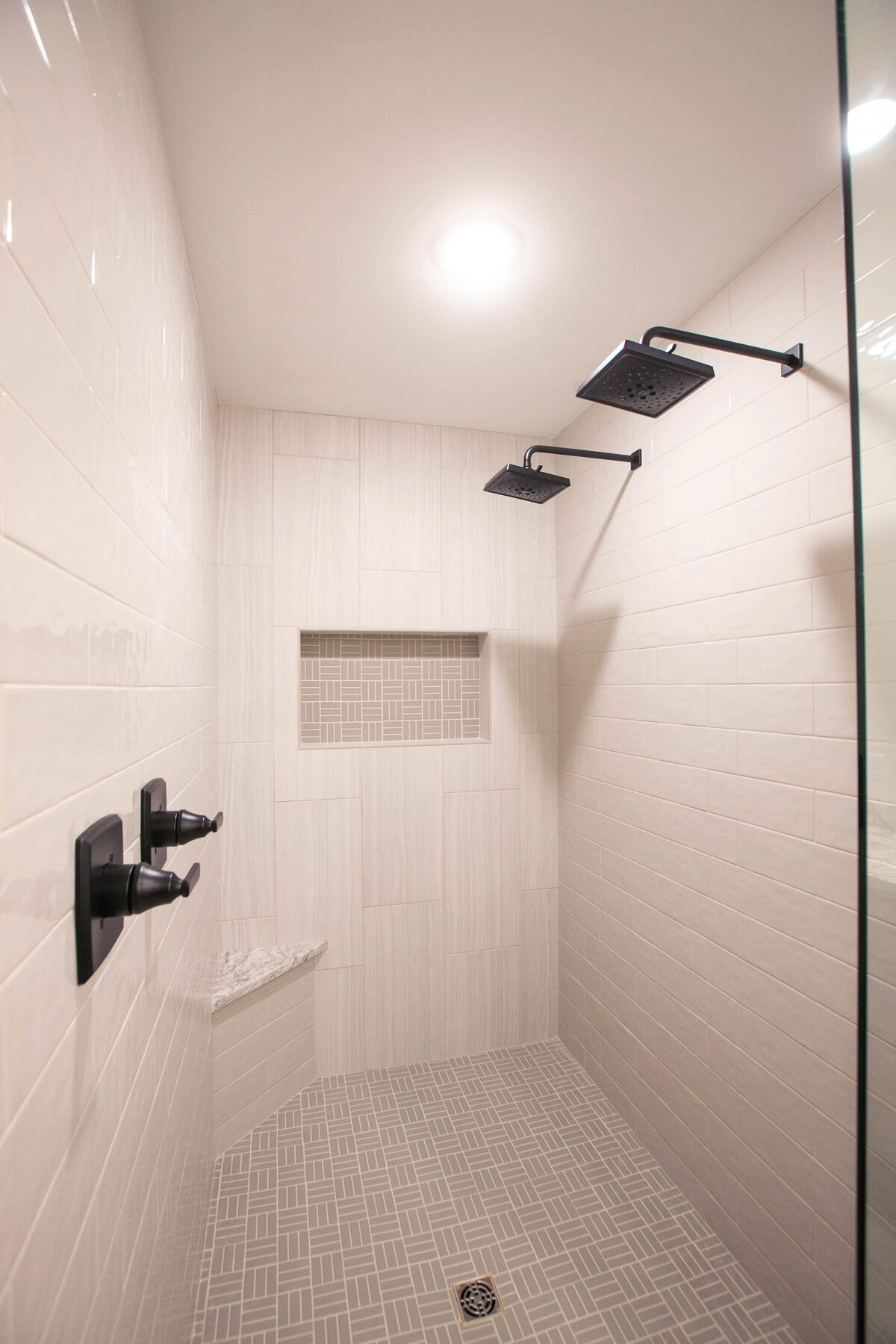 Custom bathroom with dark cabinets, double vanity, and walk-in shower in Elk River custom home
