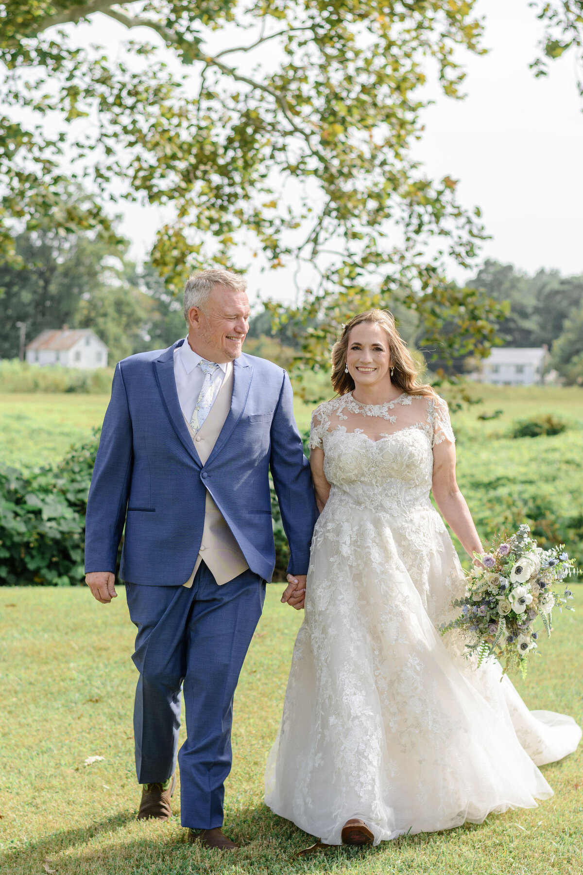 Couple walking hand in hand at there backyard wedding in Lancaster, Virginia